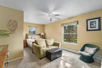 a bedroom with a bed and a couch and a chair at Wild Flower - EV #3197 in Estes Park