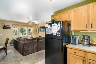 a kitchen and living room with a black refrigerator at Wild Flower - EV #3197 in Estes Park