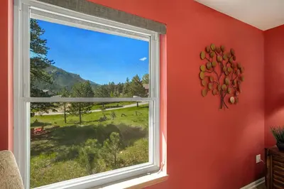 a window in a room with a view of a field at Aspen Grove Getaway - EV #3196 in Estes Park