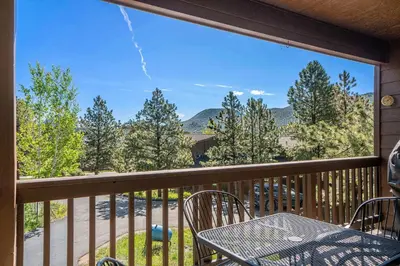 a view from a balcony with a table and chairs at Aspen Grove Getaway - EV #3196 in Estes Park