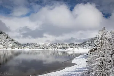 a lake covered in snow with mountains in the background at Aspen Grove Getaway - EV #3196 in Estes Park