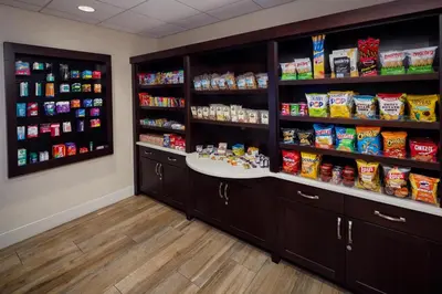 a store room with shelves filled with food at Homewood Suites by Hilton Denver International Airport in Denver
