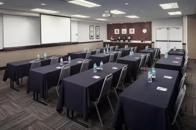 a conference room with black tables and chairs at Homewood Suites by Hilton Denver International Airport in Denver
