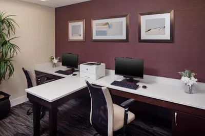 an office with two desks with computers on them at Homewood Suites by Hilton Denver International Airport in Denver