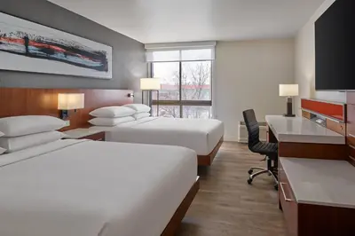 a hotel room with two beds and a desk at Delta Hotels by Marriott Denver Thornton in Westminster