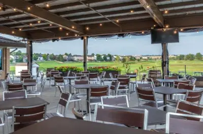 a restaurant with white tables and chairs and a field at Delta Hotels by Marriott Denver Thornton in Westminster