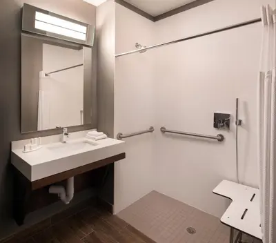 a bathroom with a sink and a mirror at Courtyard Denver Airport at Gateway Park in Denver