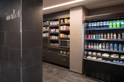 a drink aisle in a store with soda bottles at Courtyard Denver Airport at Gateway Park in Denver