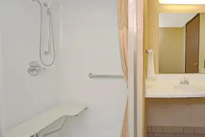 a bathroom with a shower and a sink at Super 8 by Wyndham Wheat Ridge/Denver West in Wheat Ridge