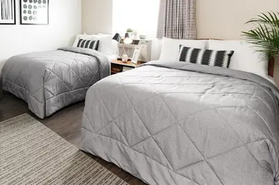 a bedroom with two twin beds and a table at InTown Suites Extended Stay Select Denver - Aurora South in Aurora