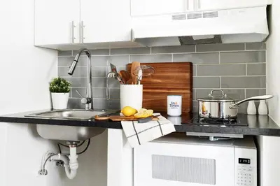 a kitchen counter with a sink and a stove at InTown Suites Extended Stay Select Denver - Aurora South in Aurora