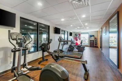 a gym with several treadmills and elliptical machines at Comfort Suites Near Denver Downtown in Denver