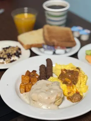 a plate of breakfast food on a table at Plaza Hotel Denver Central in Denver