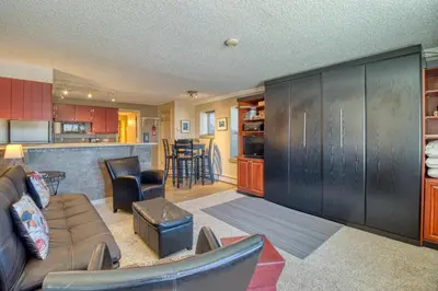 a living room with a couch and a kitchen at Silver Queen 7300 in Silverthorne