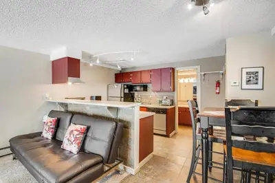 a living room with a couch and a kitchen at Silver Queen 7300 in Silverthorne
