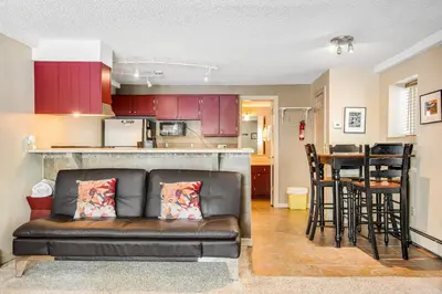 a living room with a couch and a kitchen at Silver Queen 7300 in Silverthorne