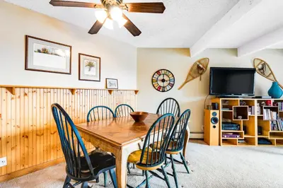a dining room with a wooden table and chairs at 2 Bed 1 Bath Apartment in Wildernest, CO in Silverthorne