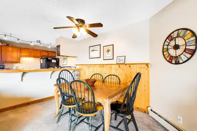 a kitchen and dining room with a wooden table and chairs at 2 Bed 1 Bath Apartment in Wildernest, CO in Silverthorne