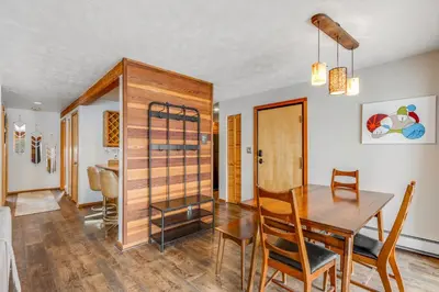 a dining room with a wooden table and chairs at 2 Bed 2 Bath Apartment in Summit County in Silverthorne