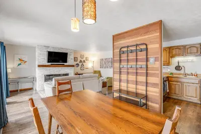 a kitchen and living room with a table and a couch at 2 Bed 2 Bath Apartment in Summit County in Silverthorne