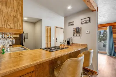 a kitchen with a wooden counter top and chairs at 2 Bed 2 Bath Apartment in Summit County in Silverthorne