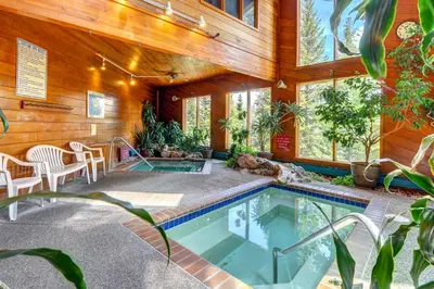 a swimming pool in a house with wooden walls at 2 Bed 2 Bath Apartment in Summit County in Silverthorne