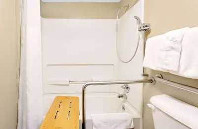 a small bathroom with a shower and a toilet at Super 8 by Wyndham Denver Central in Denver