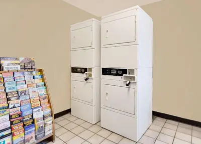 a kitchen with two white cabinets and a stove at Super 8 by Wyndham Denver Central in Denver