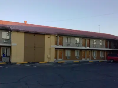 a building with a parking lot in front of it at Super 8 by Wyndham Denver Central in Denver