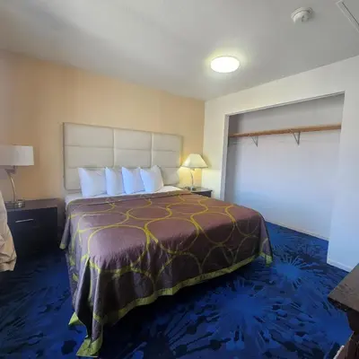 a hotel room with a bed and a large window at Super 8 by Wyndham Denver Central in Denver