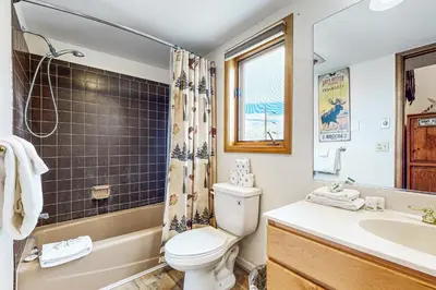 a bathroom with a toilet and a sink and a shower at 4 Bed 4 Bath Studio Apartment in Fraser in Fraser
