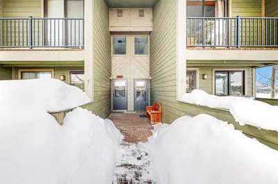 a house with snow piled up on the side of it at 4 Bed 4 Bath Studio Apartment in Fraser in Fraser