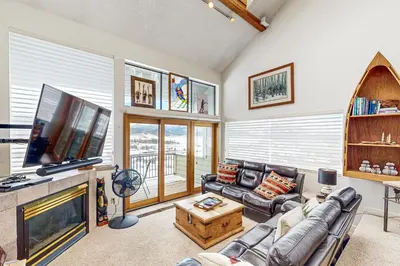 a living room with a tv and a couch and a fireplace at 4 Bed 4 Bath Studio Apartment in Fraser in Fraser
