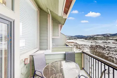 a patio with a table and chairs on a balcony at 4 Bed 4 Bath Studio Apartment in Fraser in Fraser