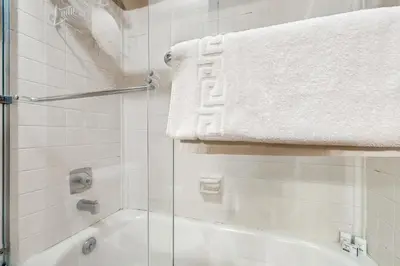 a bathroom with a shower and a bath tub with a towel at Beaver Village in Winter Park