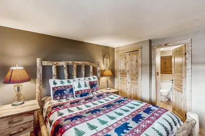 a bedroom with a bed with a colorful bedspread at Beaver Village in Winter Park