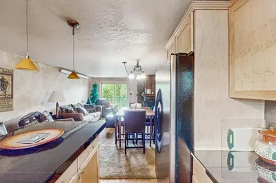 a kitchen and a living room with a couch at Beaver Village in Winter Park