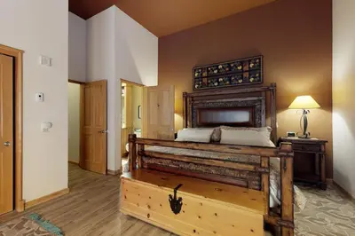 a bedroom with a large bed with a wooden headboard at River Run Village in Keystone