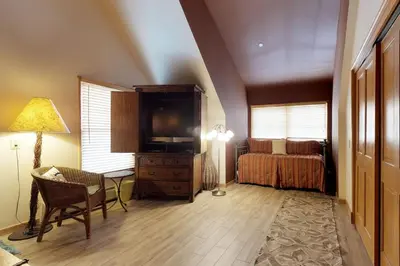 a room with a bedroom with a bed and a lamp at River Run Village in Keystone