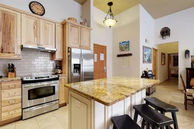 a kitchen with a counter and a stove top oven at River Run Village in Keystone