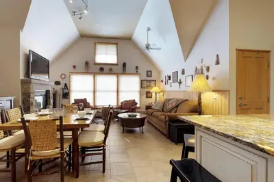 a living room with a table and a couch at River Run Village in Keystone