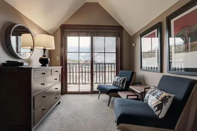 a living room with a couch and a chair and a dresser at River Run Village in Keystone