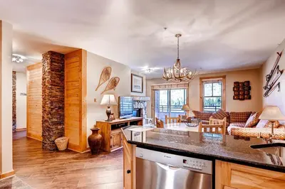 a kitchen and living room with a counter top at River Run Village in Keystone
