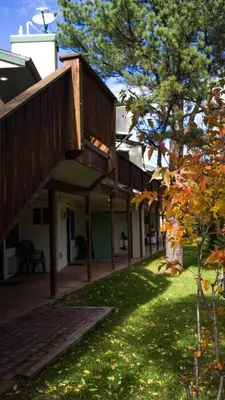 an outside view of a building with a tree at Appenzell Inn in Estes Park