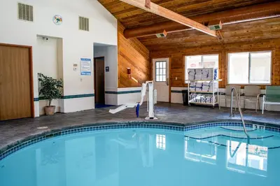 a swimming pool in a building with wooden ceilings at Appenzell Inn in Estes Park