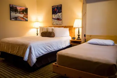 a hotel room with two beds and two lamps at Appenzell Inn in Estes Park