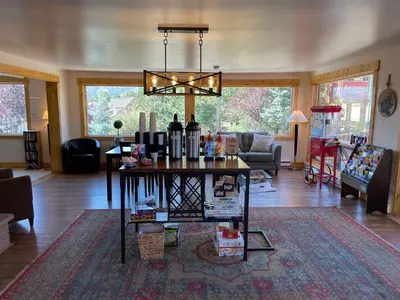 a living room with a table with wine bottles on it at Appenzell Inn in Estes Park