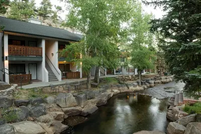 a river in front of a building at Silver Moon Inn in Estes Park