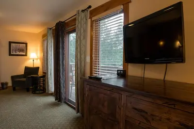 a living room with a large flat screen television at Silver Moon Inn in Estes Park