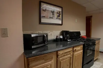 a kitchen with a microwave and a stove top oven at Silver Moon Inn in Estes Park